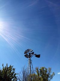 Low angle view of traditional windmill against blue sky