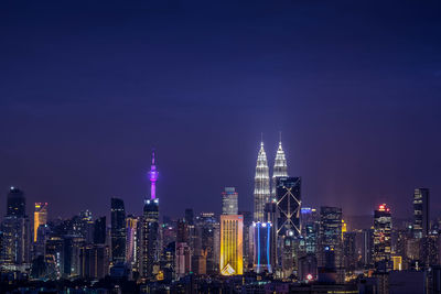 View of skyscrapers lit up at night