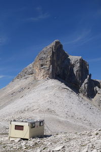 Scenic view of mountain against blue sky