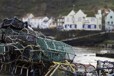 Fishing net at harbor against buildings