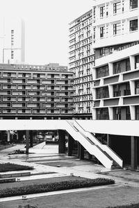 Road by building against sky in city