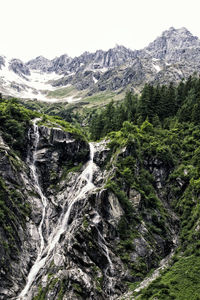 Scenic view of waterfall against sky