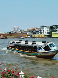 Boats moored in river against clear sky