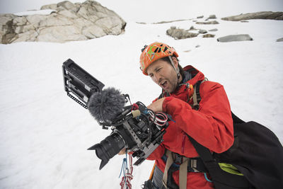 Film maker watches his playback screen in awe of the footage he shot.