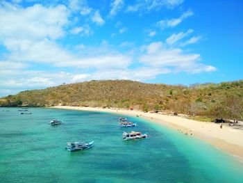 Scenic view of bay torquise ocean against blue cloudy sky. 