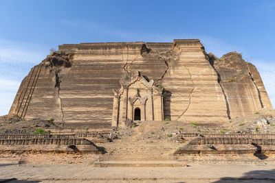 Low angle view of old ruins against clear blue sky