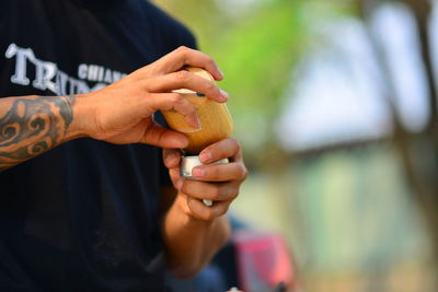 Close-up of man holding ice cream outdoors