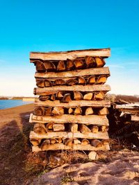 Stack of rocks by sea against sky