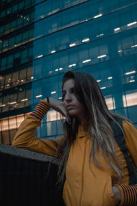 Young woman looking down in city