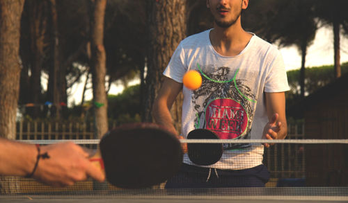 Midsection of man playing table tennis