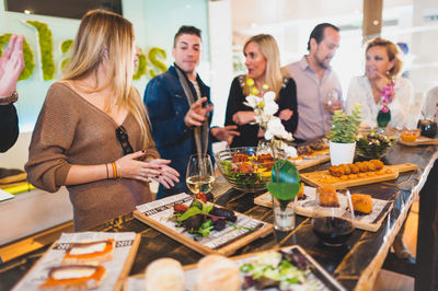 Friends discussing while having food at table in restaurant