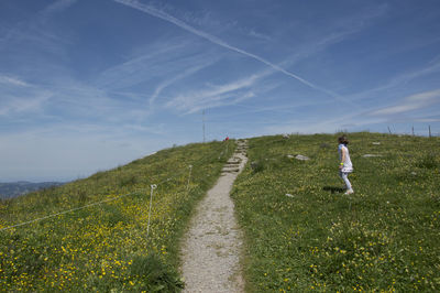 Scenic view of grassy field against sky