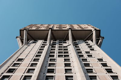 Low angle view of modern building against clear blue sky