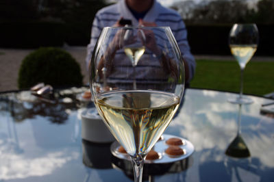 Close-up of wine glasses on table