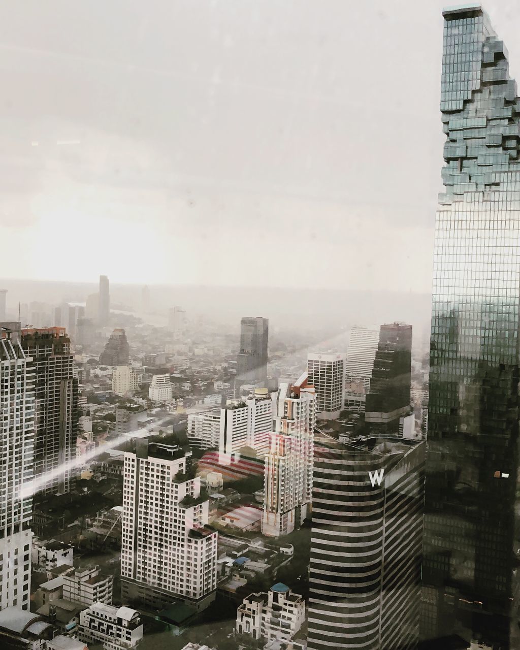 HIGH ANGLE VIEW OF MODERN BUILDINGS AGAINST SKY