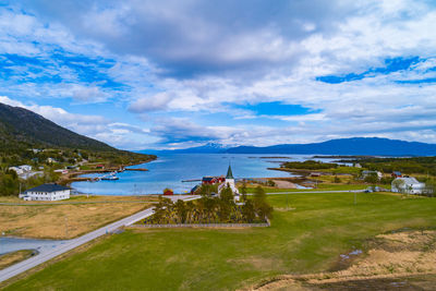 Scenic view of lake by buildings against sky