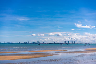 Scenic view of beach against blue sky