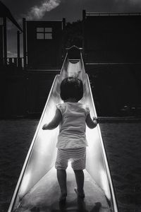 Rear view of woman standing at playground