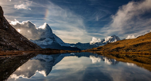 Scenic view of lake and mountains against sky