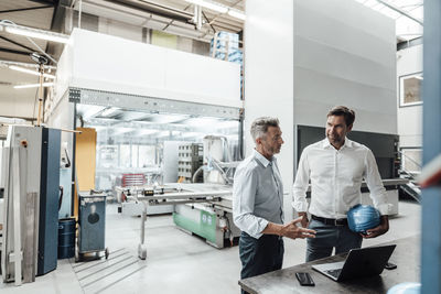 Men standing in factory