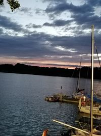 Sailboats in sea against sky during sunset