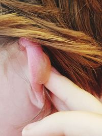 Close-up of woman with hand in hair