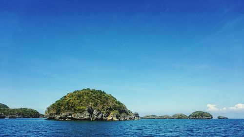 Scenic view of sea against clear blue sky