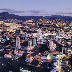 High angle view of city lit up at night