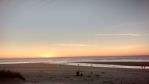 Scenic view of beach against sky during sunset