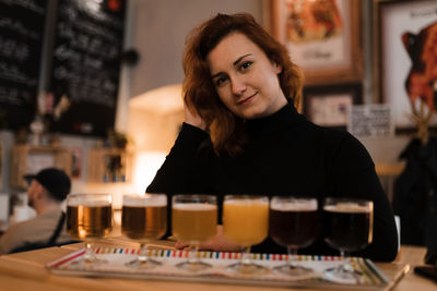 Portrait of woman with drink in restaurant