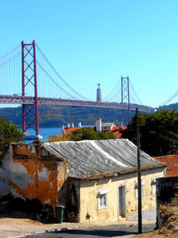 View of suspension bridge against clear blue sky. april 25th bridge. lisbon portugal