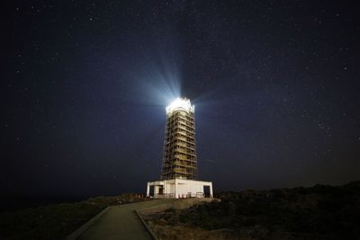 Low angle view of illuminated building against sky at night