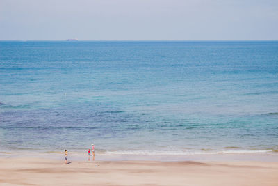 Scenic view of people relaxing at the beach