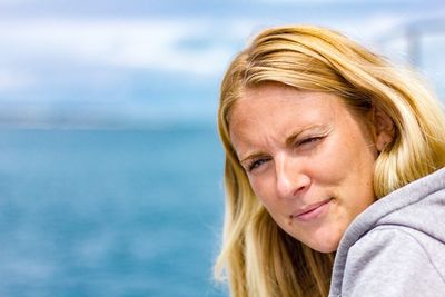 Close-up of mid adult woman against sea