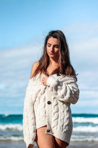 Young woman standing at beach