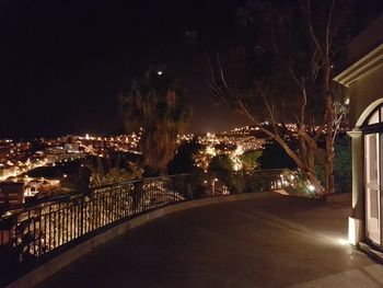 Illuminated cityscape against sky at night