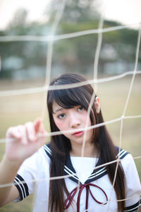 Portrait of a young woman holding camera