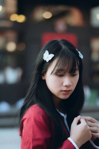 Close-up of girl looking away at night