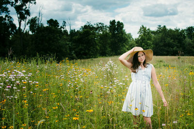 Teen girl walking through a wild flower field in southern michigan