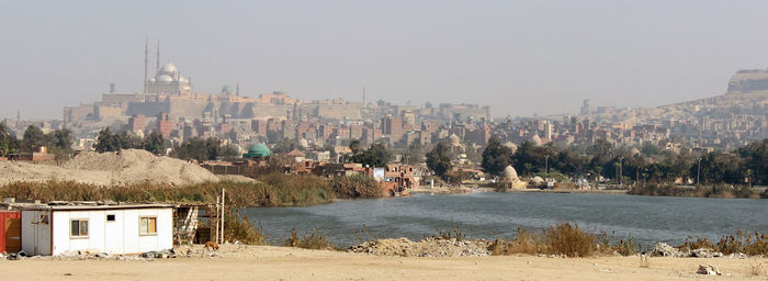 Panoramic view of beach and buildings against sky