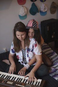 Young women playing a keyboard