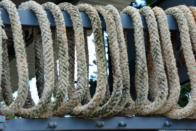 Close-up of rope hanging on fence
