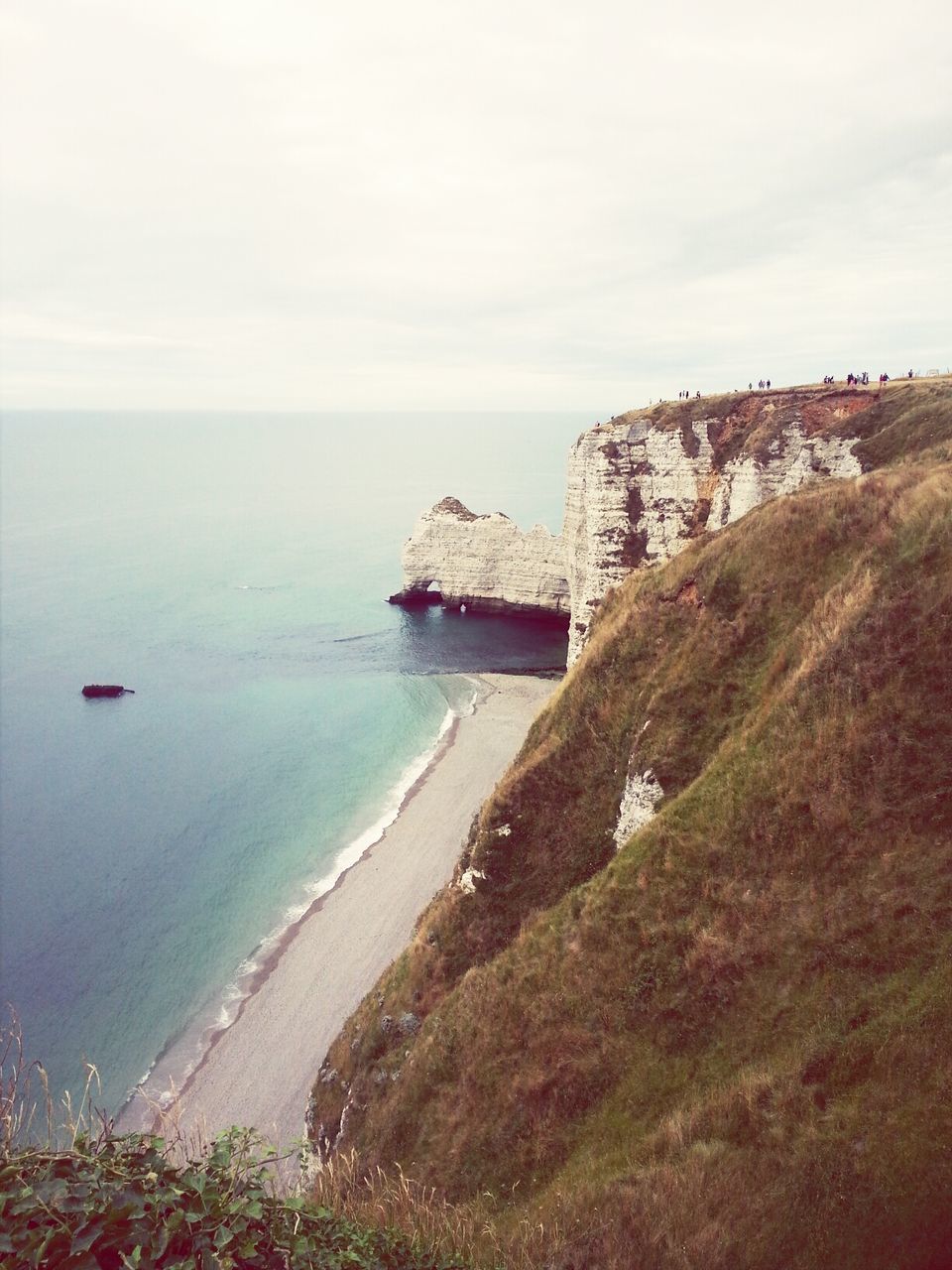 sea, horizon over water, water, beach, sky, shore, tranquil scene, tranquility, scenics, beauty in nature, coastline, nature, built structure, high angle view, architecture, idyllic, rock - object, day, cliff, incidental people