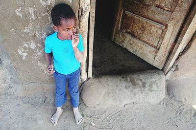 Full length of girl standing on wall