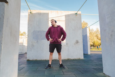 Full length portrait of man standing against built structure