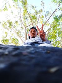 Low section portrait of man against trees