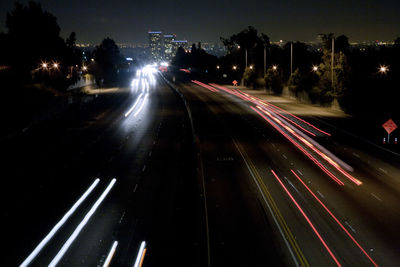 High angle view of light trails on road at night