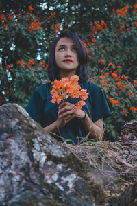 Portrait of a beautiful young woman lying down on land