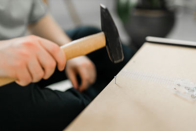 Midsection of man working on table