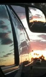 Reflection of clouds in side-view mirror